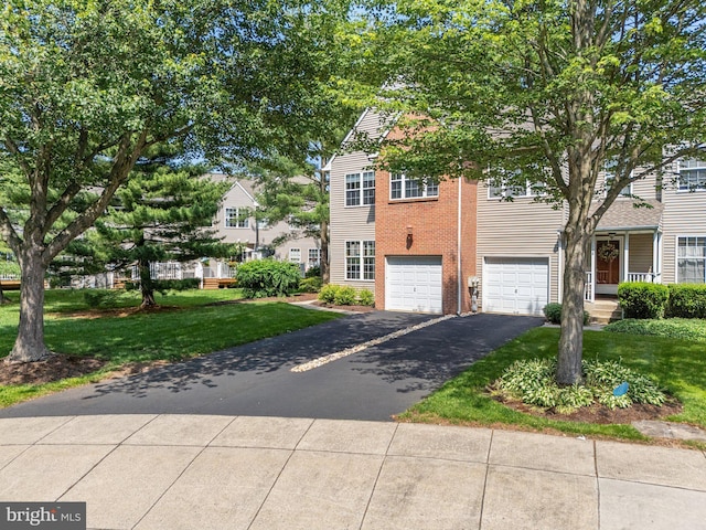 197 Victoria Ct, Doylestown, PA 18901 - view of front facade with asphalt driveway, a garage, a front lawn, and brick siding