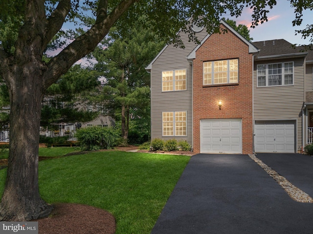 197 Victoria Ct, Doylestown, PA 18901 - view of front facade featuring driveway, an attached garage, brick siding, and a yard