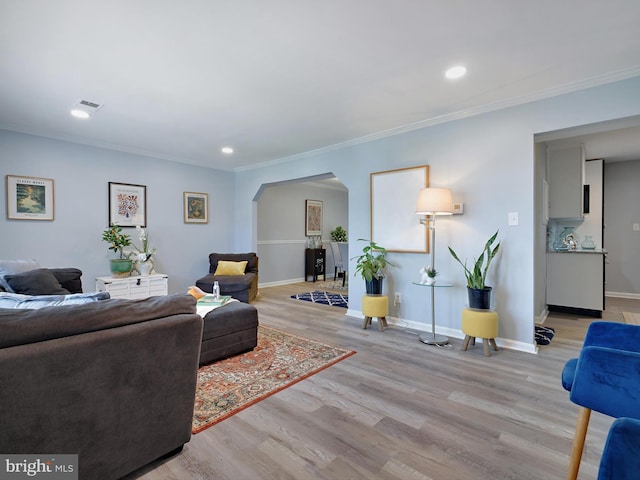 5019 Just St NE, Washington, DC 20019 - living room featuring arched walkways, light wood-type flooring, baseboards, ornamental molding, and recessed lighting