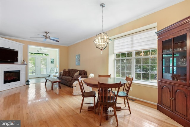 151 Lattice Ln, Collegeville, PA 19426 - dining room with healthy amount of natural light, light wood-style floors, ornamental molding, a chandelier, and a ceiling fan