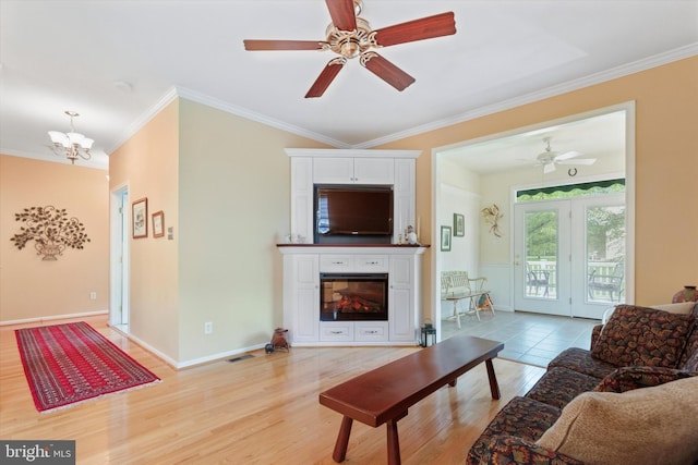 151 Lattice Ln, Collegeville, PA 19426 - living area featuring a glass covered fireplace, light wood finished floors, crown molding, ceiling fan, and a chandelier