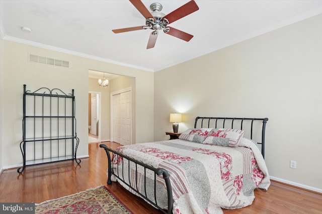 151 Lattice Ln, Collegeville, PA 19426 - bedroom with crown molding, wood finished floors, a chandelier, ceiling fan, and connected bathroom