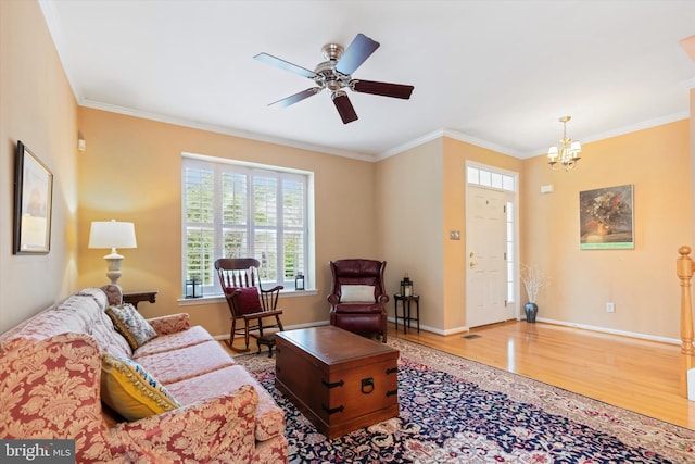 151 Lattice Ln, Collegeville, PA 19426 - living room featuring wood finished floors, crown molding, a chandelier, and a ceiling fan