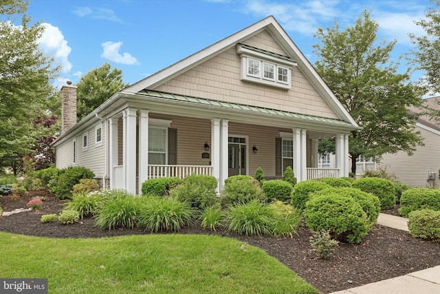 151 Lattice Ln, Collegeville, PA 19426 - view of front of property with a standing seam roof, covered porch, a chimney, a metal roof, and a front yard
