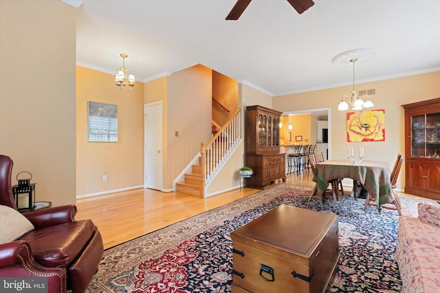 151 Lattice Ln, Collegeville, PA 19426 - living area featuring a chandelier, stairs, wood finished floors, ornamental molding, and a ceiling fan