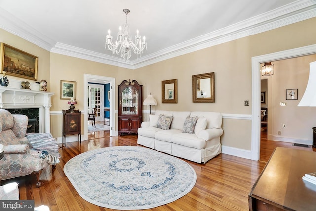 35175 Snickersville Tpke, Round Hill, VA 20141 - living room featuring a chandelier, crown molding, wood finished floors, baseboards, and a fireplace