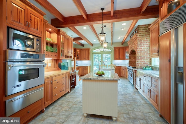 35175 Snickersville Tpke, Round Hill, VA 20141 - kitchen featuring built in appliances, a warming drawer, beamed ceiling, backsplash, and a center island with sink