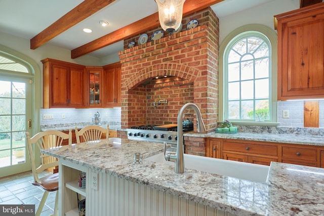 35175 Snickersville Tpke, Round Hill, VA 20141 - kitchen with brown cabinets, beamed ceiling, light stone countertops, decorative backsplash, and a sink