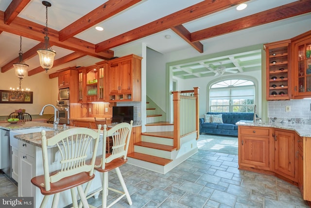 35175 Snickersville Tpke, Round Hill, VA 20141 - kitchen featuring appliances with stainless steel finishes, beam ceiling, backsplash, ceiling fan, and light stone counters