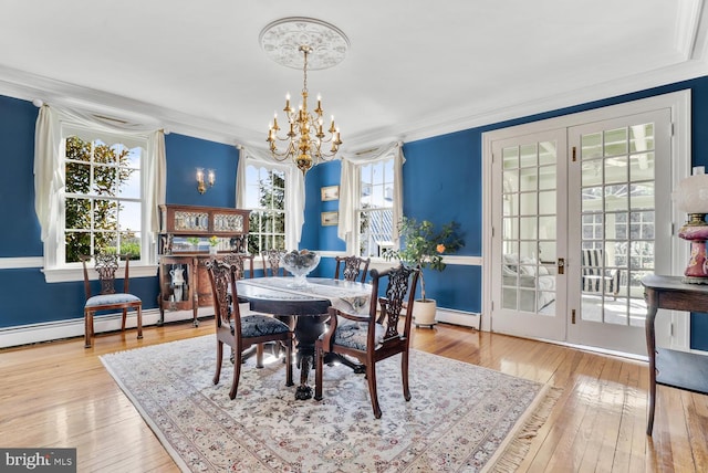 35175 Snickersville Tpke, Round Hill, VA 20141 - dining area featuring a baseboard radiator, a chandelier, wood-type flooring, and ornamental molding