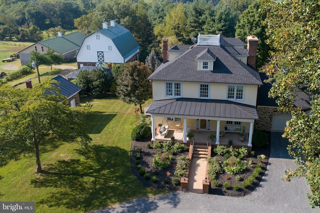 35175 Snickersville Tpke, Round Hill, VA 20141 - view of front of property with stucco siding, a chimney, covered porch, a front lawn, and a standing seam roof