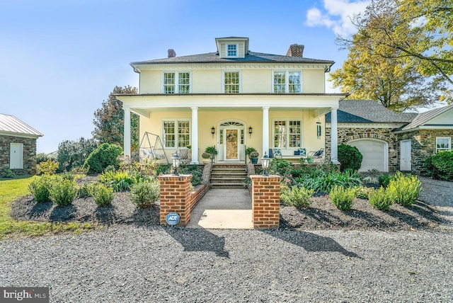 35175 Snickersville Tpke, Round Hill, VA 20141 - american foursquare style home with a porch, stucco siding, an attached garage, a chimney, and stone siding