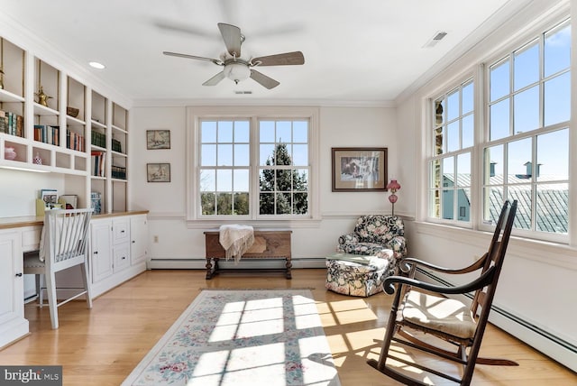 35175 Snickersville Tpke, Round Hill, VA 20141 - sitting room featuring crown molding, a baseboard heating unit, a ceiling fan, and light wood-style floors