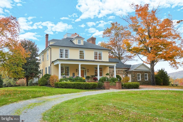 35175 Snickersville Tpke, Round Hill, VA 20141 - view of front of house featuring a chimney, stucco siding, a front yard, stone siding, and covered porch
