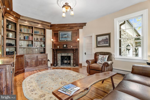 35175 Snickersville Tpke, Round Hill, VA 20141 - living area featuring light wood-style flooring, a baseboard radiator, a fireplace, a chandelier, and baseboards
