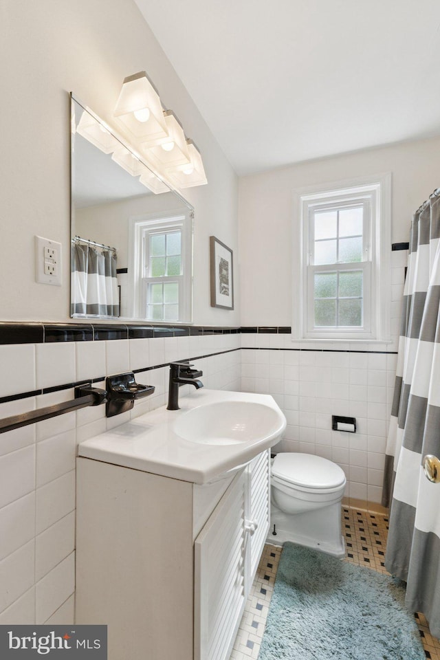 2907 Summerfield Rd, Falls Church, VA 22042 - bathroom with tile walls, vanity, healthy amount of natural light, tile patterned floors, and curtained shower