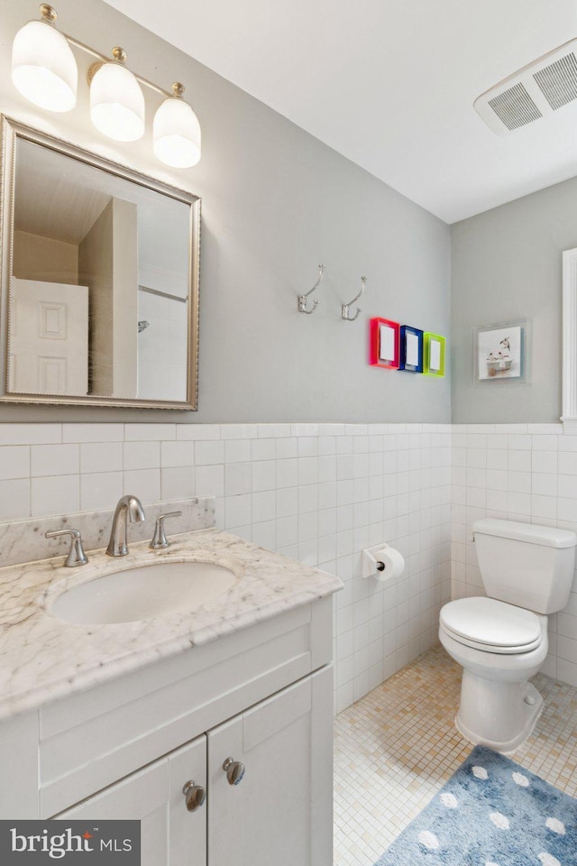2907 Summerfield Rd, Falls Church, VA 22042 - bathroom featuring tile walls, vanity, and wainscoting