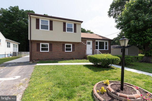 3220 Dupuy Rd, Colonial Heights, VA 23834 - tri-level home with brick siding, a front yard, and central air condition unit