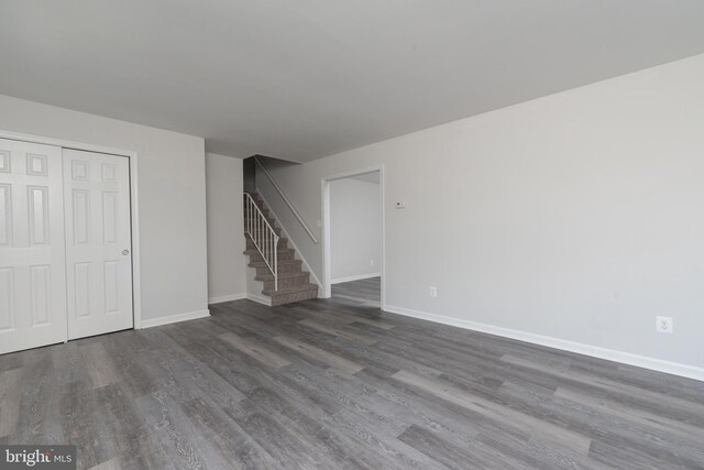 3220 Dupuy Rd, Colonial Heights, VA 23834 - unfurnished living room featuring stairs, wood finished floors, and baseboards