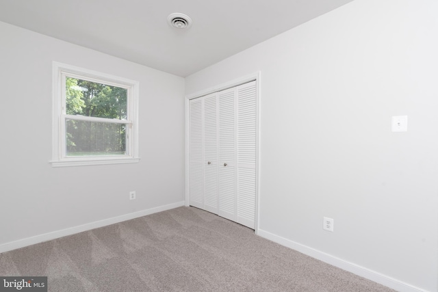 3220 Dupuy Rd, Colonial Heights, VA 23834 - unfurnished bedroom featuring carpet floors, a closet, and baseboards