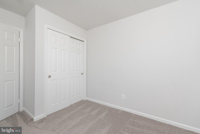 3220 Dupuy Rd, Colonial Heights, VA 23834 - unfurnished bedroom with light colored carpet, baseboards, and a closet