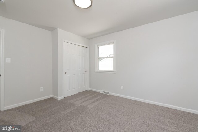 3220 Dupuy Rd, Colonial Heights, VA 23834 - unfurnished bedroom with carpet flooring, baseboards, and a closet