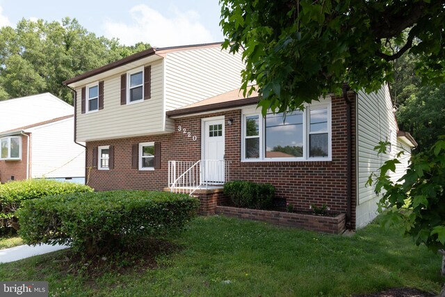 3220 Dupuy Rd, Colonial Heights, VA 23834 - tri-level home featuring brick siding and a front lawn