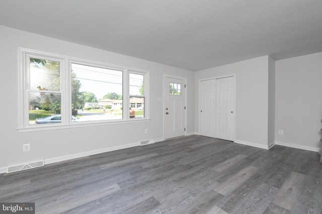 3220 Dupuy Rd, Colonial Heights, VA 23834 - unfurnished living room featuring healthy amount of natural light, dark wood-type flooring, and baseboards