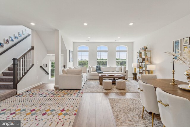 5504 Lanteen St, Lanham, MD 20706 - living area featuring wood finished floors, stairs, recessed lighting, and baseboards
