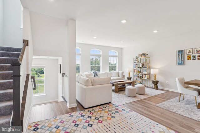 5504 Lanteen St, Lanham, MD 20706 - living room featuring wood finished floors, stairs, plenty of natural light, baseboards, and recessed lighting