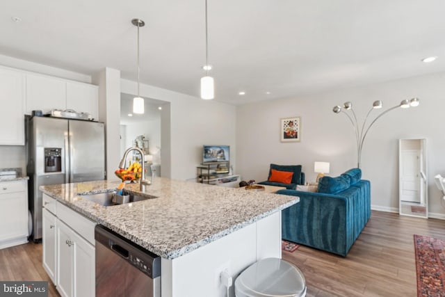 5504 Lanteen St, Lanham, MD 20706 - kitchen with stainless steel appliances, open floor plan, a sink, light wood finished floors, and recessed lighting