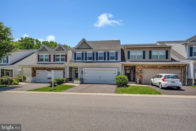 9726 Knowledge Dr, Laurel, MD 20723 - multi unit property featuring driveway, a garage, and stone siding