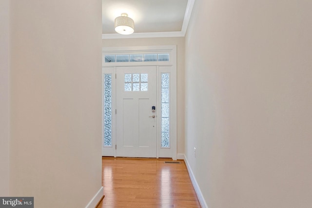 9726 Knowledge Dr, Laurel, MD 20723 - foyer featuring crown molding, light wood-style floors, and baseboards
