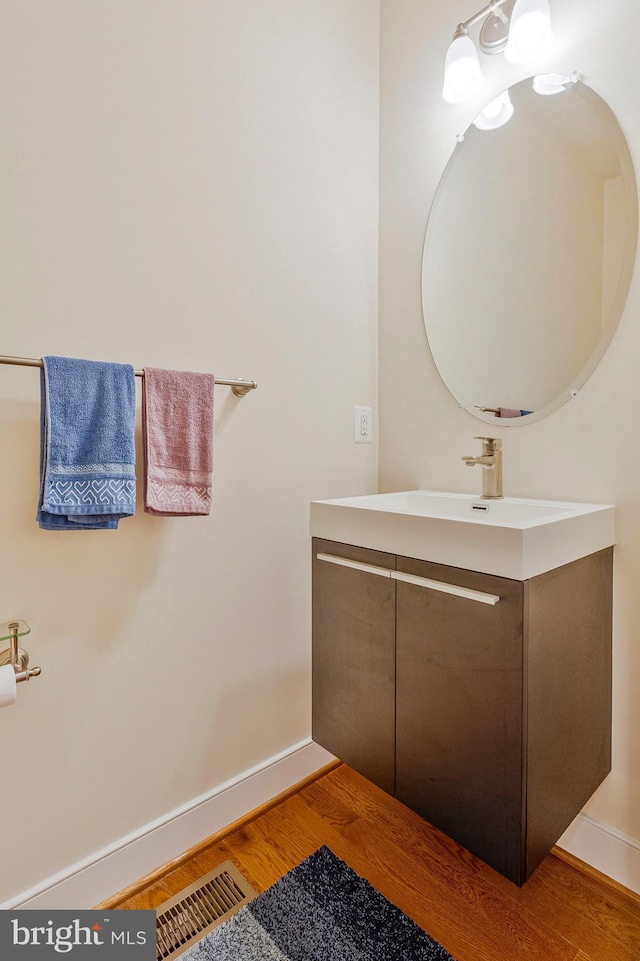 9726 Knowledge Dr, Laurel, MD 20723 - bathroom with wood finished floors, vanity, and baseboards