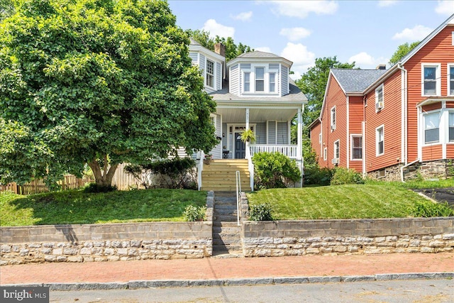 413 E A St, Brunswick, MD 21716 - view of front facade with covered porch and a front lawn