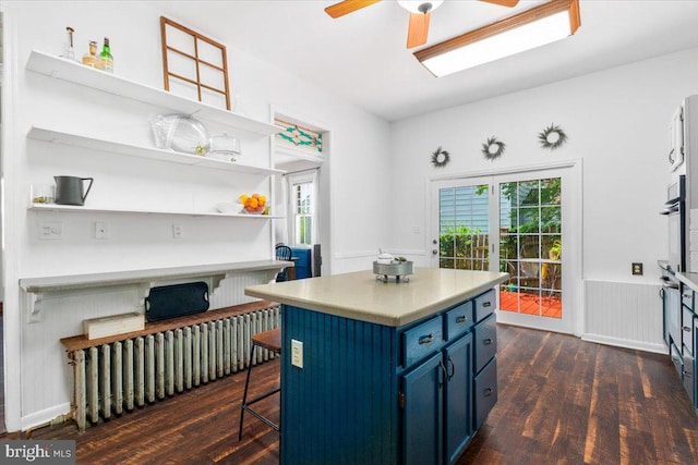413 E A St, Brunswick, MD 21716 - kitchen with blue cabinets, dark wood-type flooring, a ceiling fan, and open shelves