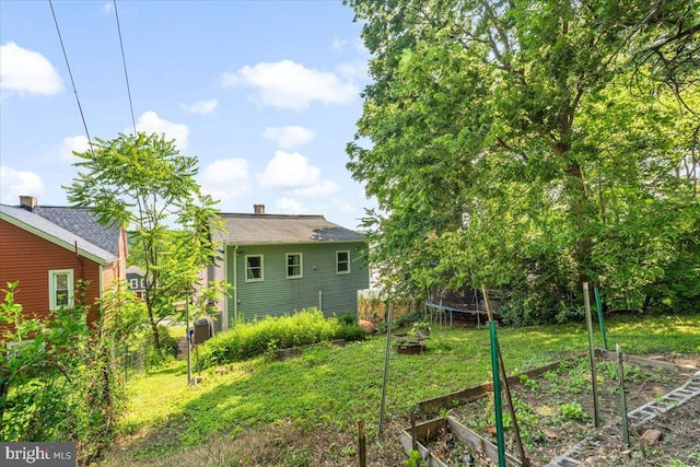 413 E A St, Brunswick, MD 21716 - view of yard featuring a vegetable garden and a trampoline