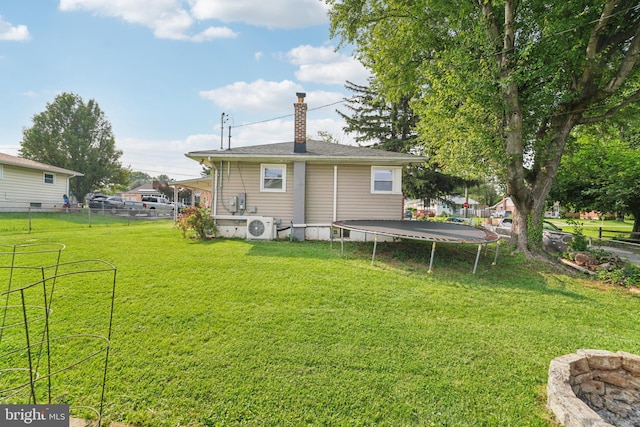 1323 Dorchester Ave, Gwynn Oak, MD 21207 - rear view of property featuring a trampoline, ac unit, and a chimney