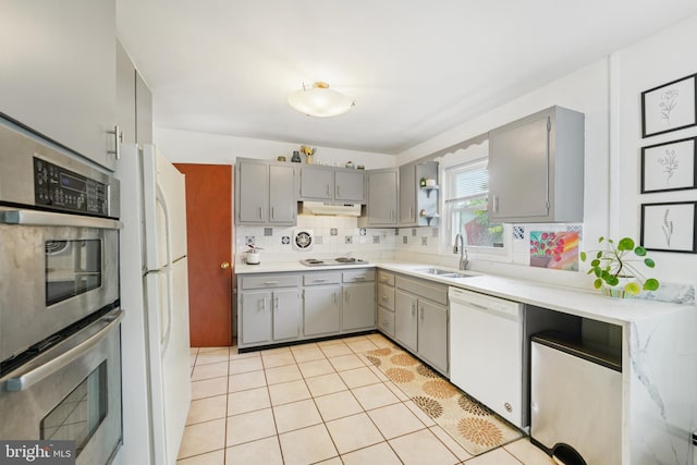 1323 Dorchester Ave, Gwynn Oak, MD 21207 - kitchen featuring white appliances, gray cabinetry, a sink, tasteful backsplash, and light countertops