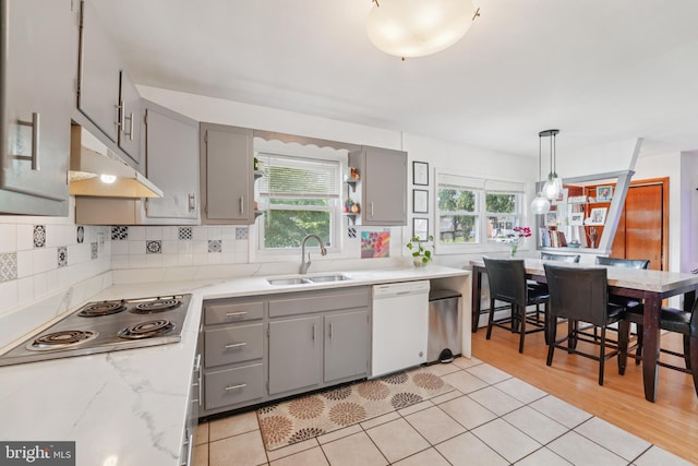 1323 Dorchester Ave, Gwynn Oak, MD 21207 - kitchen with white dishwasher, a sink, gray cabinets, under cabinet range hood, and stainless steel cooktop