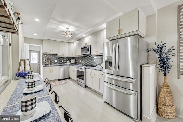 830 S E Ave, Baltimore, MD 21224 - kitchen featuring stainless steel appliances, recessed lighting, backsplash, a chandelier, and light wood-style floors