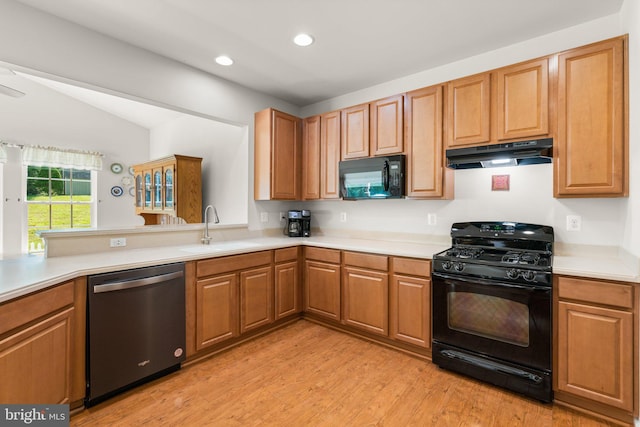 3611 Cogswell Ct, Abingdon, MD 21009 - kitchen with black appliances, under cabinet range hood, a sink, light countertops, and light wood-type flooring