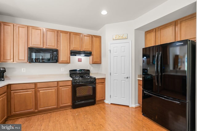 3611 Cogswell Ct, Abingdon, MD 21009 - kitchen with black appliances, under cabinet range hood, light countertops, light wood-style floors, and recessed lighting