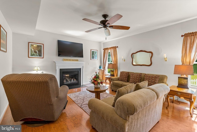 3611 Cogswell Ct, Abingdon, MD 21009 - living area featuring light wood-style flooring, a fireplace with flush hearth, a ceiling fan, and baseboards