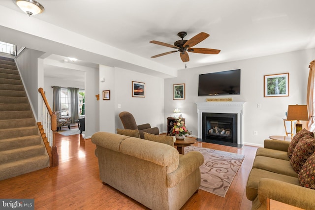 3611 Cogswell Ct, Abingdon, MD 21009 - living room featuring stairway, a ceiling fan, a glass covered fireplace, wood finished floors, and baseboards