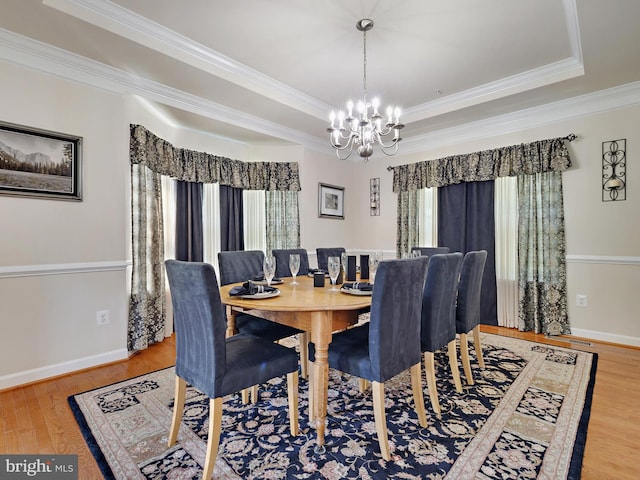 15446 Symondsbury Way, Upper Marlboro, MD 20774 - dining area with a chandelier, wood finished floors, crown molding, a tray ceiling, and baseboards