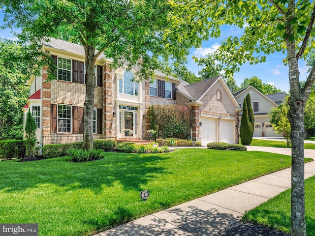 15446 Symondsbury Way, Upper Marlboro, MD 20774 - view of front of house featuring brick siding, driveway, a front yard, and a garage