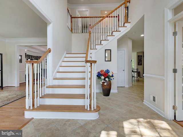 15446 Symondsbury Way, Upper Marlboro, MD 20774 - stairway featuring ornamental molding, baseboards, tile patterned floors, and a towering ceiling