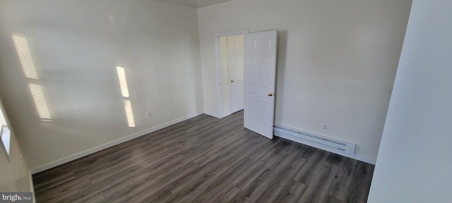 3063 Joyce St, Philadelphia, PA 19134 - spare room featuring baseboard heating, dark wood-style flooring, and baseboards