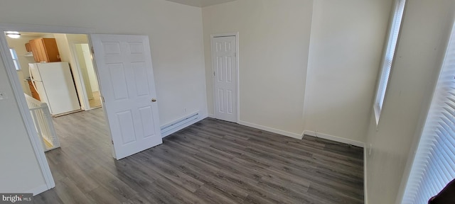 3063 Joyce St, Philadelphia, PA 19134 - unfurnished room with dark wood finished floors, baseboards, and a baseboard heating unit